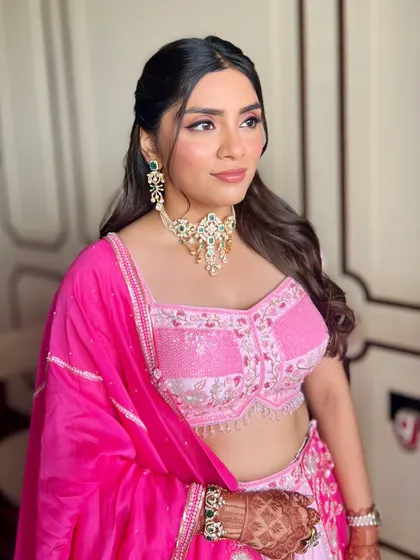 This shot captures the complete harmony between the makeup, hair, and outfit. The soft curls and glowing skin create a timeless and elegant engagement party look.