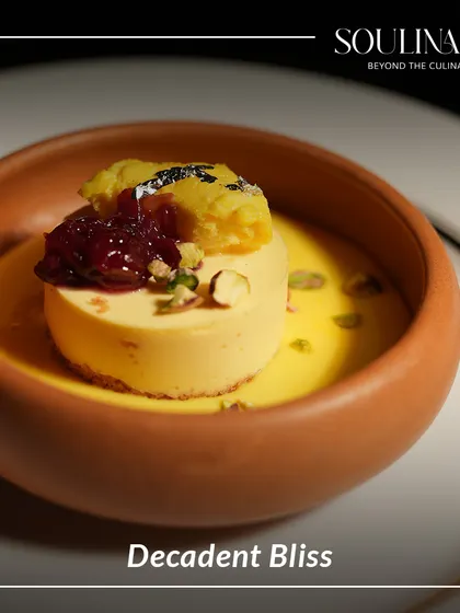 Decadent bliss in a terracotta bowl. This modern Indian dessert features a creamy base, a dollop of jam, and a crumble topping, offering a symphony of textures and flavours.