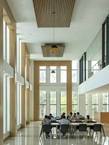 The double-height reading room at Sona University, highlighted in features for its inspiring, sunlit atmosphere. The design connects occupants with the outdoors and fosters a culture of reading and shared experience.