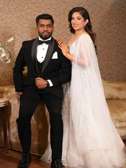 My bride Ria on her engagement night. She looked like a princess in this white gown with a cape, paired with soft waves and pearl hair accessories.