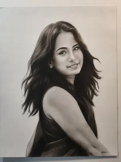 A portrait of a woman with her hair blowing gently, creating a sense of movement and life. This was drawn on A3 paper.