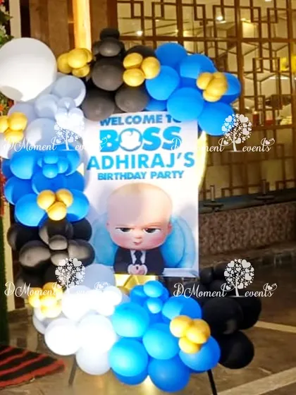 A bold and fun welcome sign for a Boss Baby party, framed with blue, black, and white balloons.