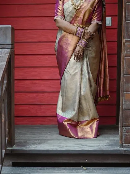 A minimalist portrait focusing on the beautiful drape and color of the bride's Kanjivaram saree.