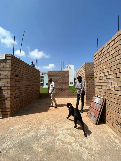 Our team inspecting the progress of mud block masonry at a new residence. We are deeply involved at every stage, ensuring the quality and integrity of the construction.