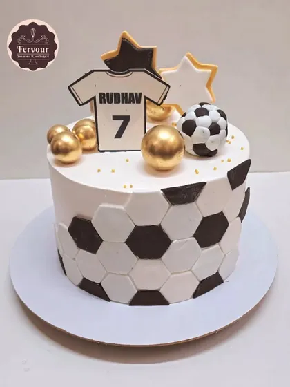 A classic football-themed cake with a jersey and soccer ball pattern. The design is clean and modern, perfect for a fan celebrating a birthday.