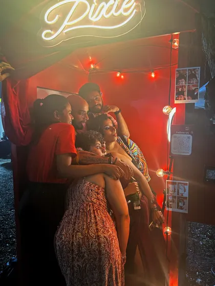 It can be a tight squeeze, but that's part of the fun. This group piled into the booth for a cozy and hilarious photo session, capturing a truly candid moment of friendship and laughter.