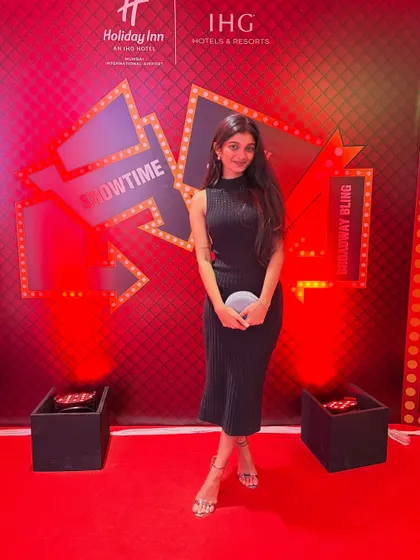 Posing on the red carpet at a corporate show. I am always professional and ready for any event.