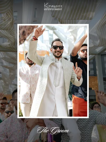 The groom makes his entrance at the Mehendi party, full of energy and ready to celebrate with his friends and family.
