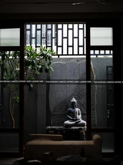 I believe a garden should bring peace that extends into your home. This view from inside shows how we can create a tranquil courtyard, featuring a serene Buddha statue and natural stone, turning your window into a living piece of art.