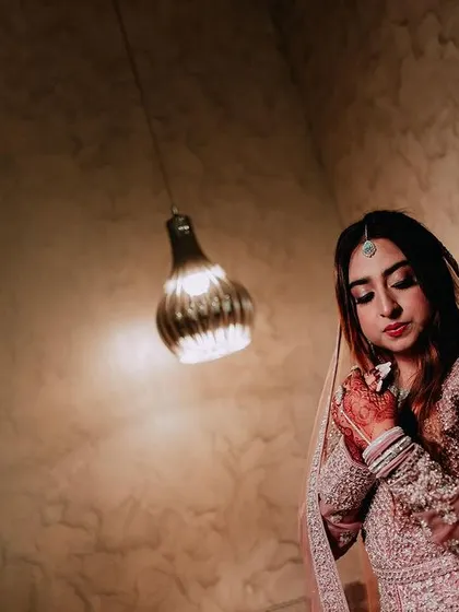 A portrait of a Muslim bride in a beautifully embellished gown, captured in a moment of quiet elegance.