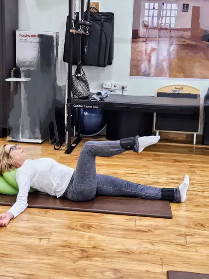 Here is a client performing a gentle leg exercise on the mat with ankle weights. We focus on slow, controlled movements to build strength without putting any strain on the joints.