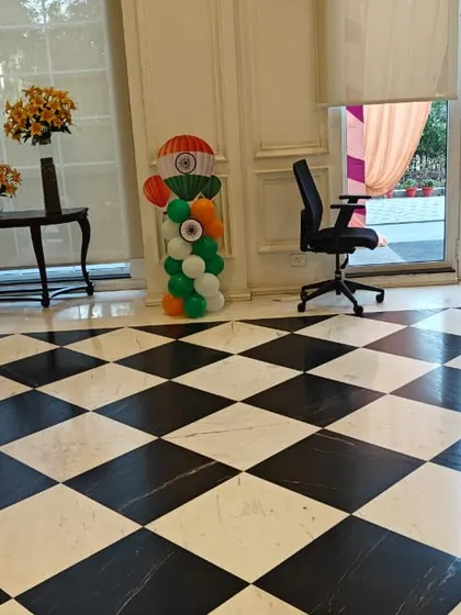 This image captures the tricolor balloon pillars placed near the entrance of a venue, showcasing a simple yet effective decoration for Independence or Republic Day.