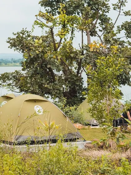 A small group enjoying a quiet morning chat outside their tents. Our campsite layout encourages both group activities and moments of peaceful interaction.