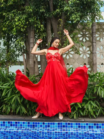 Another beautiful action shot from the red dress series, capturing the joy and energy of a celebration.