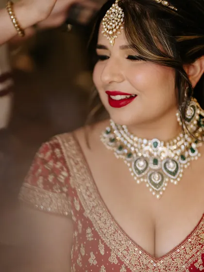 A close-up of the bold red lip and defined eyes. This look is all about confidence and timeless bridal beauty.