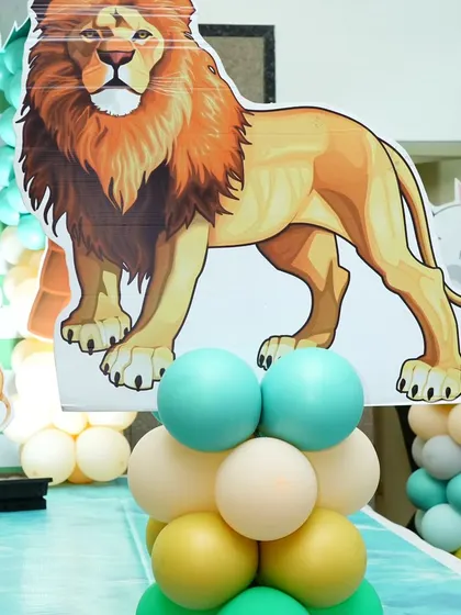 A majestic lion cutout stands proudly on a balloon pillar. These life-sized characters are fantastic for photos and making the theme feel larger than life.