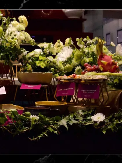 Another angle of the lush grazing table, showing how I use fresh greenery and flowers to enhance the visual appeal of the food spread.