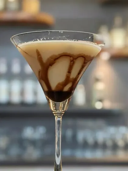 A delicious chocolate martini, with elegant chocolate syrup swirls inside the glass. A perfect dessert cocktail for any occasion.