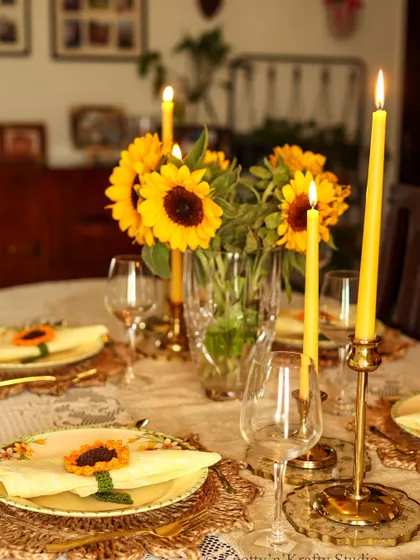 The warm glow of candles on the sunflower tablescape creates a magical atmosphere.