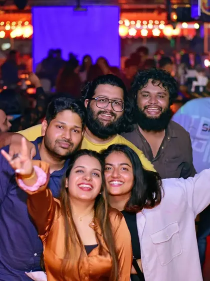 A group of friends taking a selfie, capturing the fun of the night. It's great to see people enjoying the vibe we've built together.