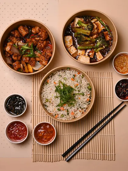 This is what gourmet delivery looks like. A complete meal with mains, rice, and sauces, all packed in eco-friendly containers and ready to serve at your table.