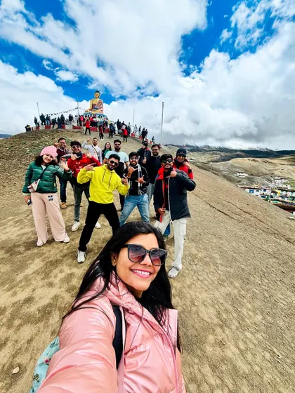 A selfie capturing the whole group on a hillside in Spiti, with the Langza Buddha visible in the background. These are the memories that last a lifetime.