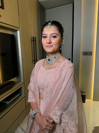 This client wanted to glow, and that's what we did. A luminous, dewy look for her in this pretty pastel pink lehenga.