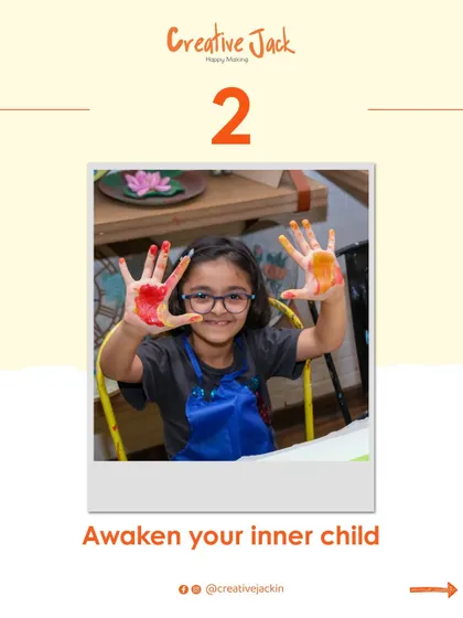 A young girl shows her paint-covered hands to the camera, a perfect picture of the "awaken your inner child" spirit of my workshops.