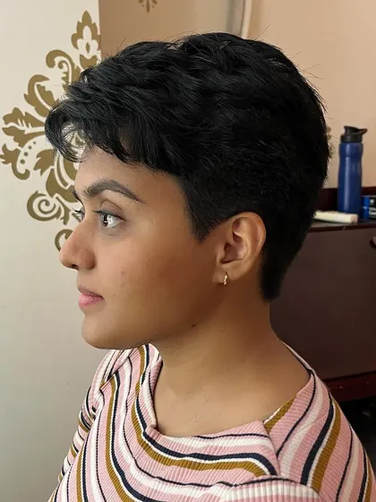 The side view shows the short, clean lines of the pixie cut.