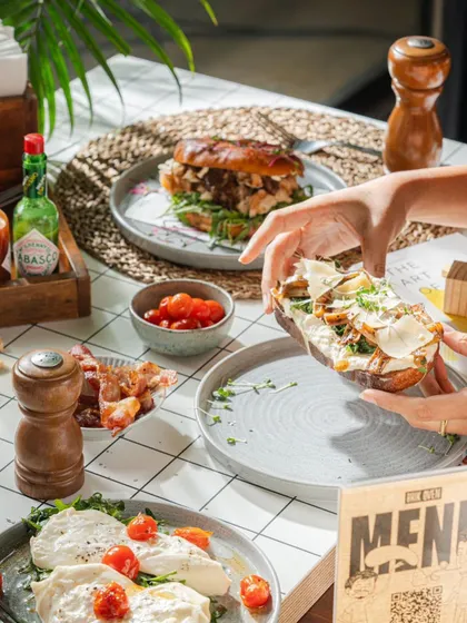A full breakfast spread at one of our tables. We love seeing our customers enjoying a variety of our handmade items, from sandwiches to burrata plates.