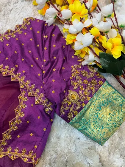 The back of the purple and green blouse, featuring a beautiful cut-out design framed with delicate gold embroidery.