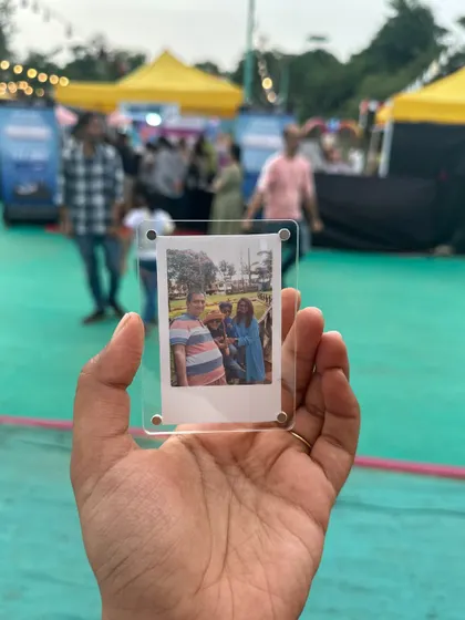 A Polaroid magnet captured at one of my live events, showing a happy family moment.