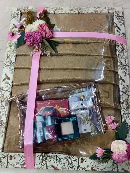 A golden dress packed with a matching cosmetics pouch. This is a great gift idea for a bride's trousseau.