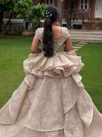 A simple and elegant ponytail for a bride in a stunning gown. The style is kept minimal to let the dramatic dress shine.