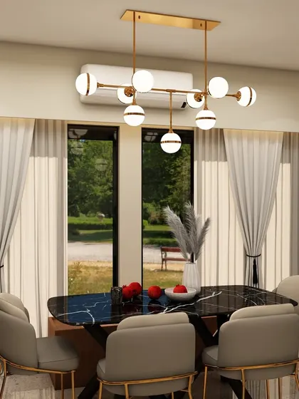 The dining area of the same project, featuring a modern chandelier over a black marble-top table, with large windows providing a beautiful view and ample daylight.