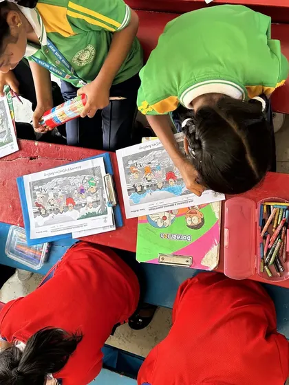 An overhead view of students deeply engaged in our coloring competition. The focus and concentration here are just as important as the colors they choose, and we love to see them so absorbed in their work.