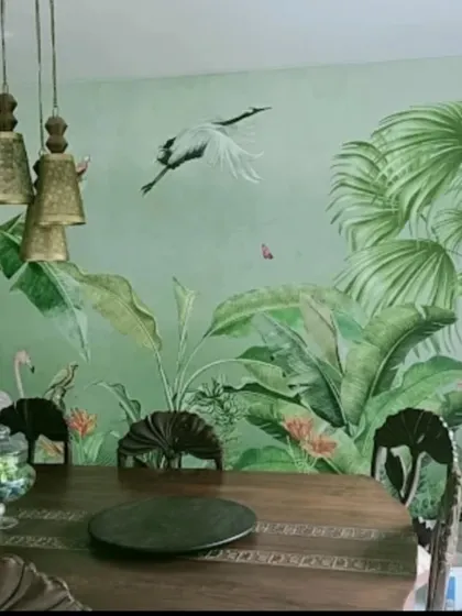 A green-toned tropical mural with a flying crane creates a refreshing and elegant dining room backdrop.