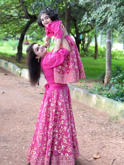 Flying high with mom. The open spaces in Bengaluru's parks are perfect for these fun, interactive shots that show your family's love and connection.