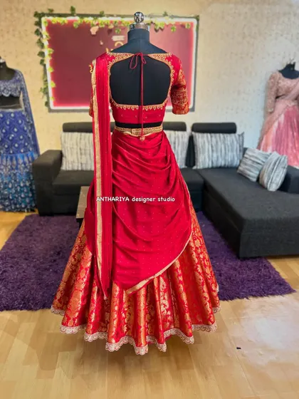 The back view of an all-red brocade lehenga, designed for a client's Bhale Shastra event.