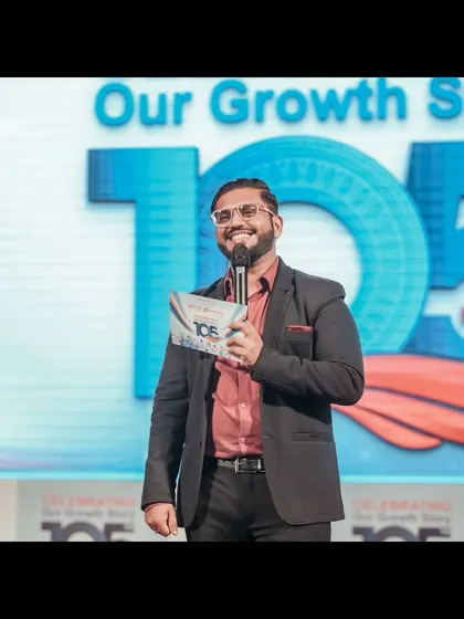 A smile is the best accessory on stage. This was captured during a corporate foundation day, where my goal was to keep the mood celebratory and engaging for everyone attending.