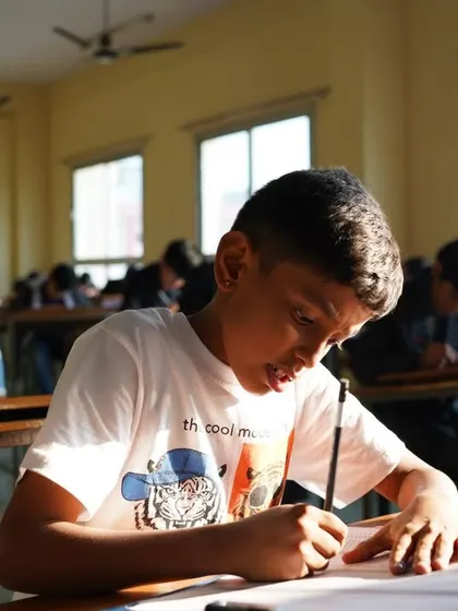 A student writing furiously to keep up with the fast pace of the competition.
