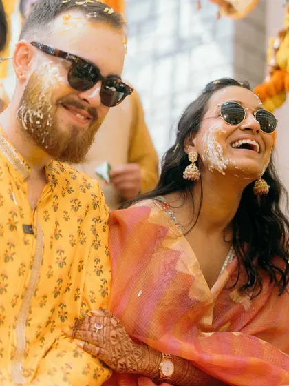 The Haldi ceremony is all about vibrant color and unrestrained fun. Ben and Shrutika, covered in turmeric and happiness, share a laugh that is completely genuine and infectious. These are the real moments.