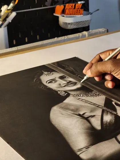 My hand adding final touches to the portrait.