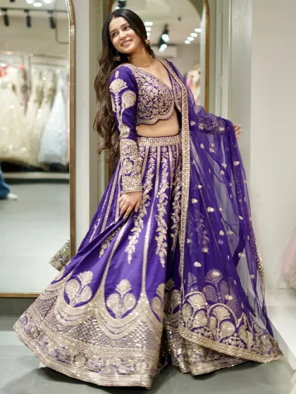 This majestic purple lehenga is a true statement piece. The rich color combined with heavy gold embroidery makes it perfect for a royal wedding look.