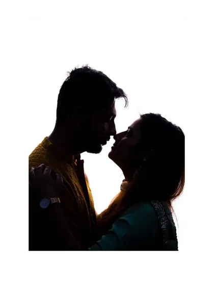 Another take on the silhouette, capturing the moment just before a kiss. This pre-wedding shot is full of romantic tension and artistry.
