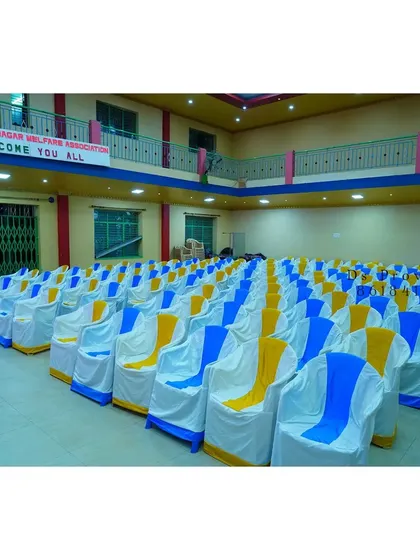 For larger gatherings or corporate functions, I can arrange for seating with chair covers that match your event's color scheme. Here, I used white covers with blue and yellow sashes.