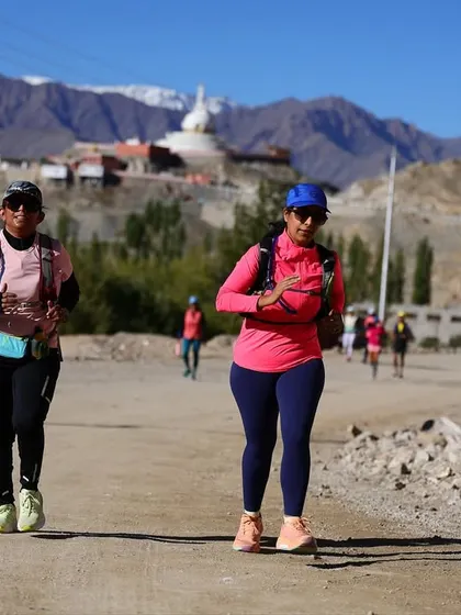 Two runners pacing each other on a dusty trail during the Ladakh Marathon. The sense of teamwork and mutual support is crucial in these endurance events.