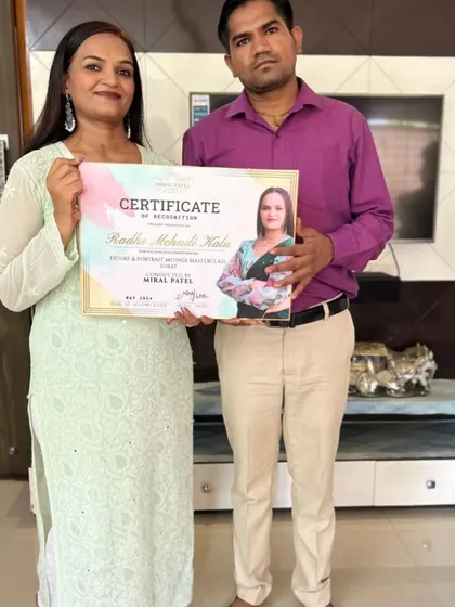 Receiving a certificate of recognition for a Radha-Krishna and portrait mehndi masterclass. I specialize in teaching these advanced skills.
