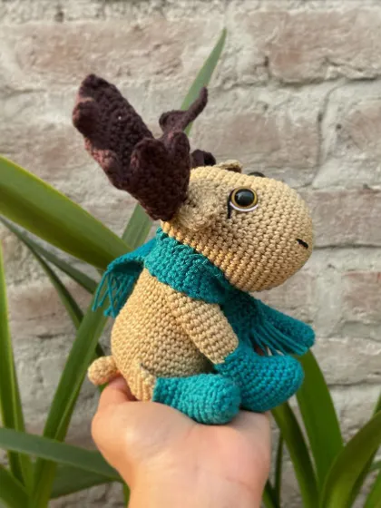 The side view of the moose amigurumi shows off his antlers and fringed scarf. He was a very fun and detailed project to work on.