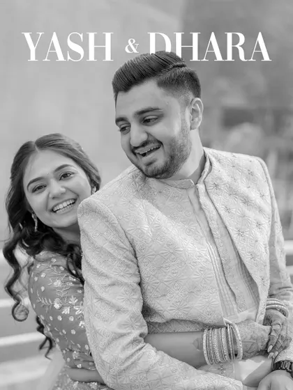 A classic black and white engagement portrait. The couple's joyful, natural smiles and the clean composition make this a timeless and heartwarming image.